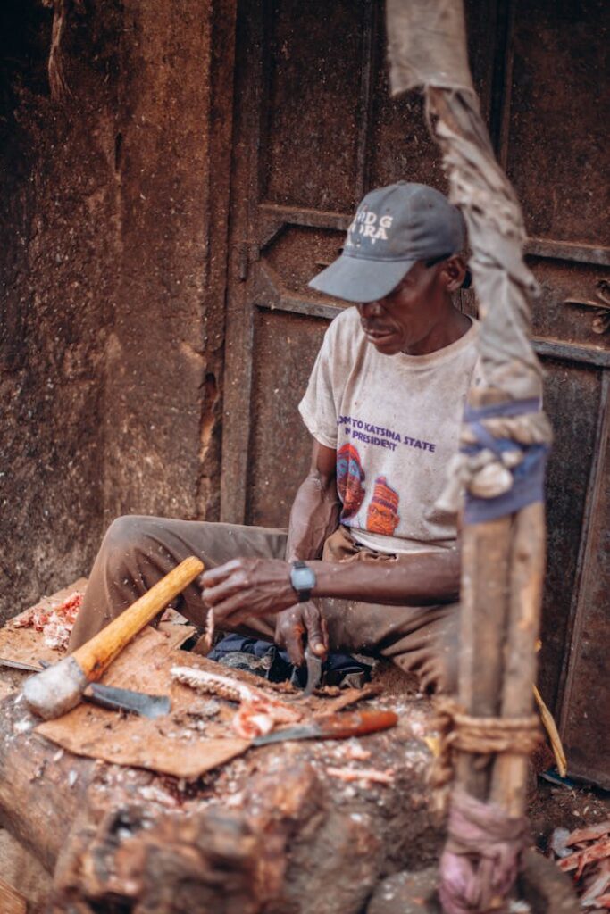 A skilled artisan meticulously crafts wood, showcasing traditional craftsmanship using hand tools.