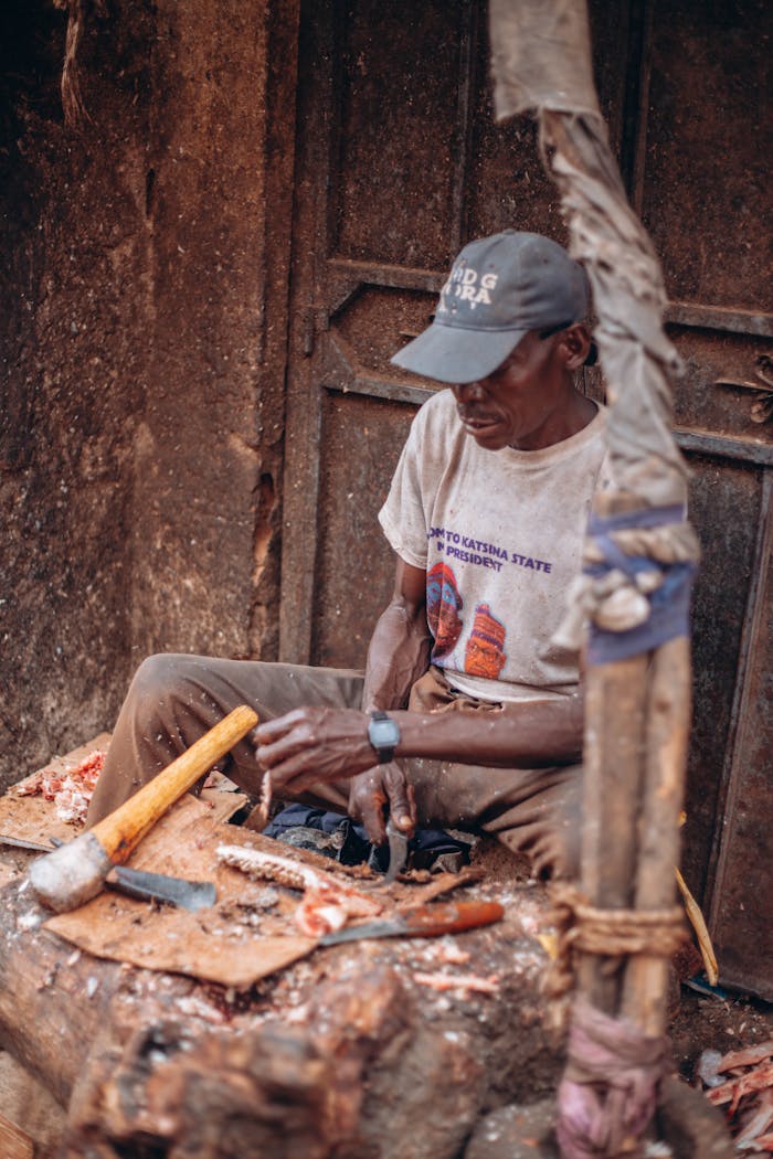 A skilled artisan meticulously crafts wood, showcasing traditional craftsmanship using hand tools.