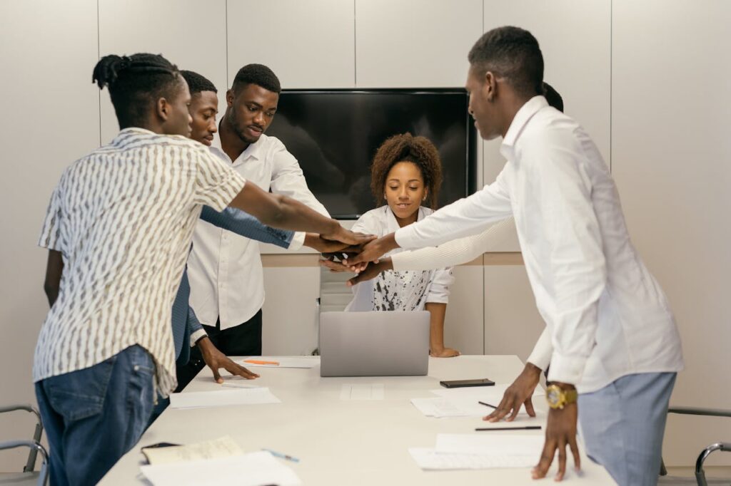 Diverse team engaged in a collaborative meeting around a table in a modern office setting.